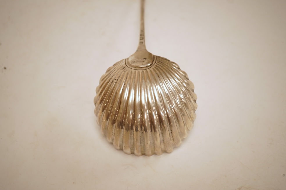 A late George II silver feather edge Old English pattern soup ladle, with fluted bowl, by Richard Rugg, London, 1759, 34cm, 5oz.